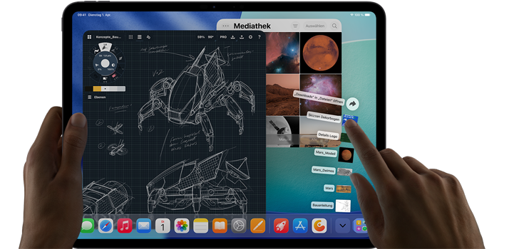 iPad Pro, Farbe Space Schwarz, die linke Hand einer Person hält das Gerät, die rechte Hand passt mit Gesten mehrere geöffnete App Fenster an, darunter eine Zeichenapp mit Skizzen von mechanischen Designs, eine Fotomediathek mit Planeten und Weltraumbildern und Dateien im Download-Ordner, die nach oben hin aufgefächert werden